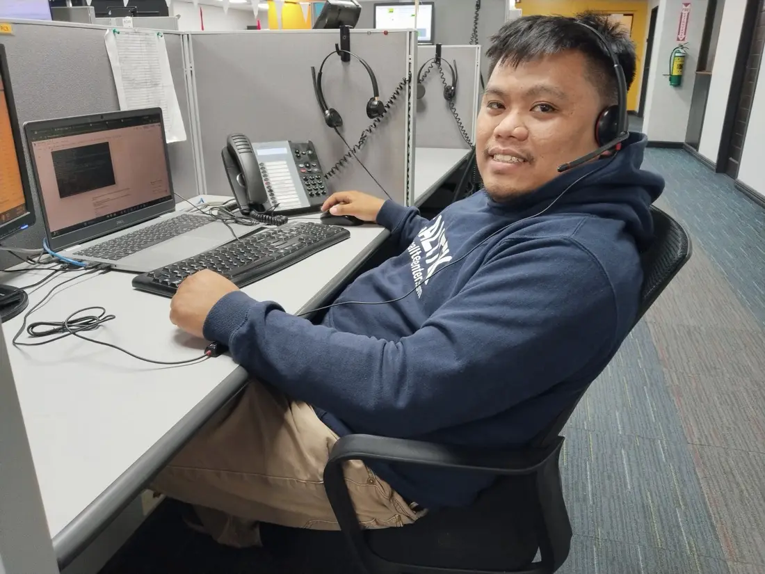 Terrence wearing a headset at his workstation