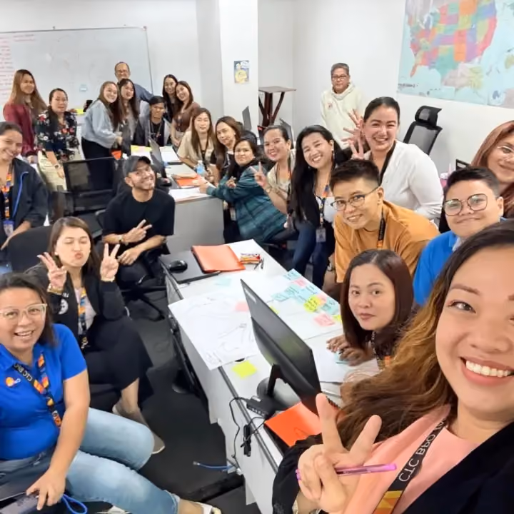 A training room full of smiling employees