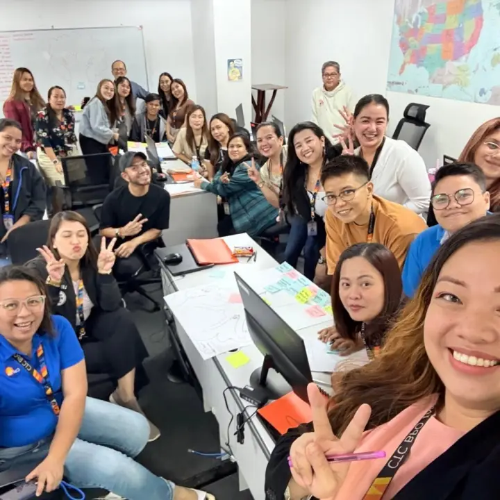 A training room full of smiling employees