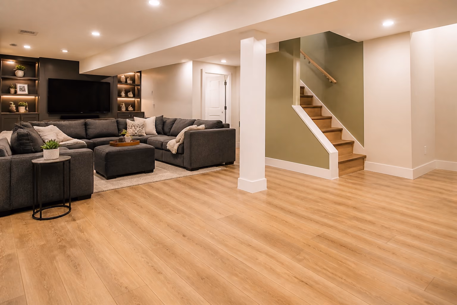 Finished basement family room with light wood-look flooring