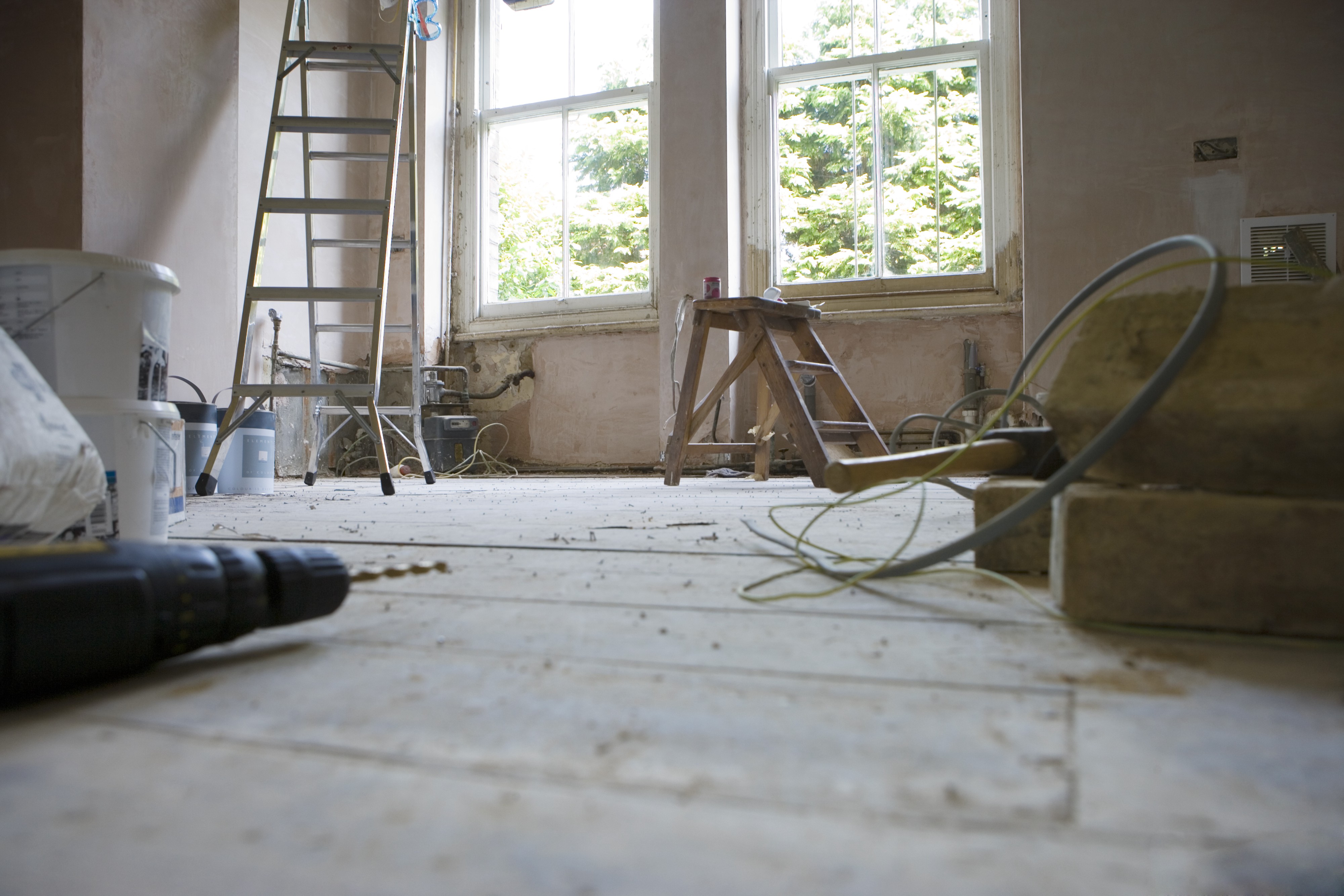 Active interior renovation with ladders and tools