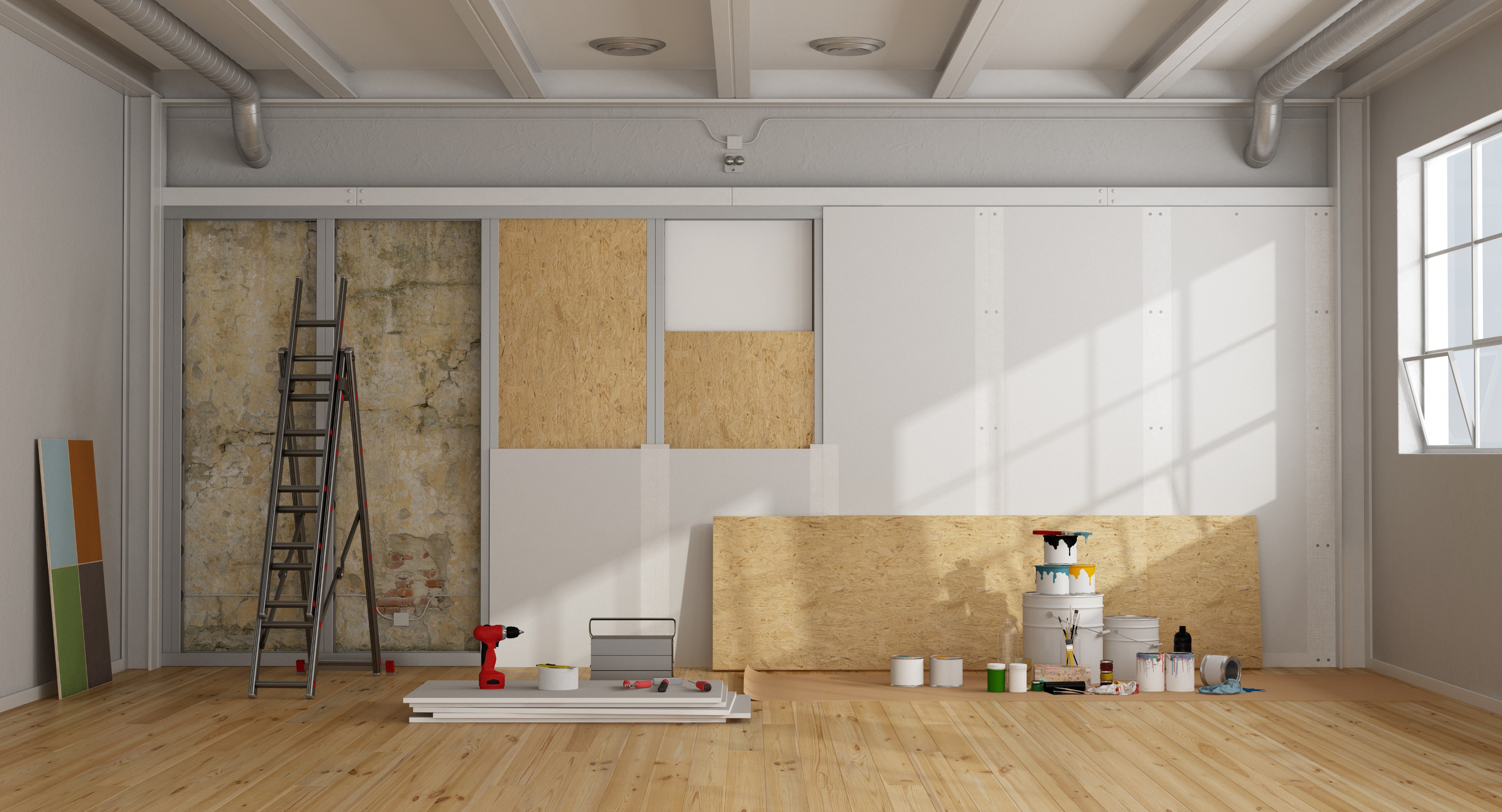 Wide interior workspace prepared for drywall installation and painting