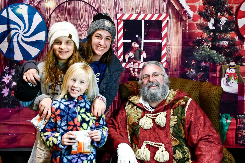 Sisters and mom with Santa
