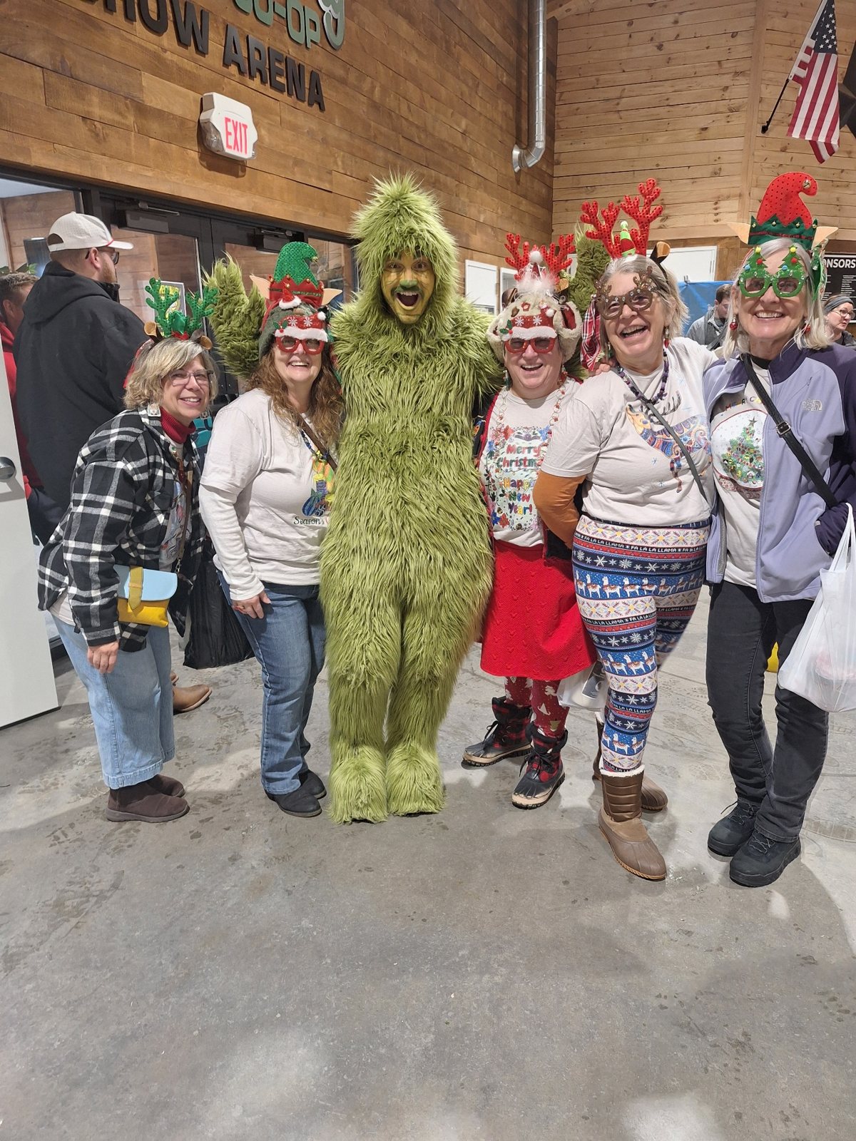 Market visitors in holiday gear with the Grinch