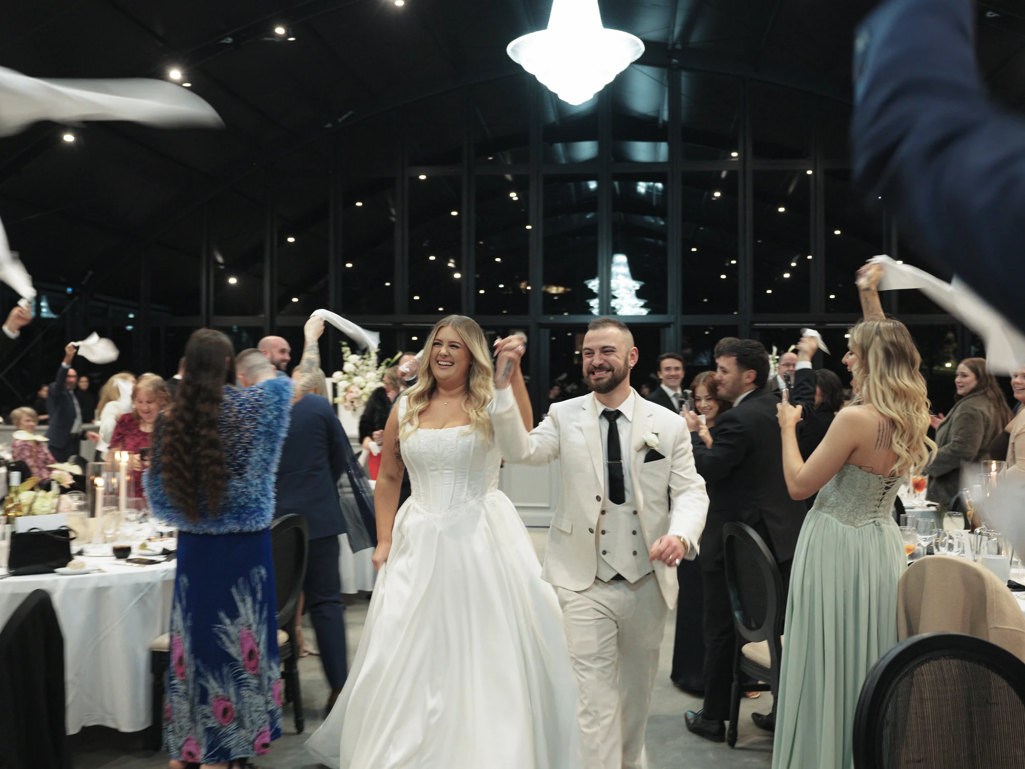 Couple celebrating with guests in a reception room