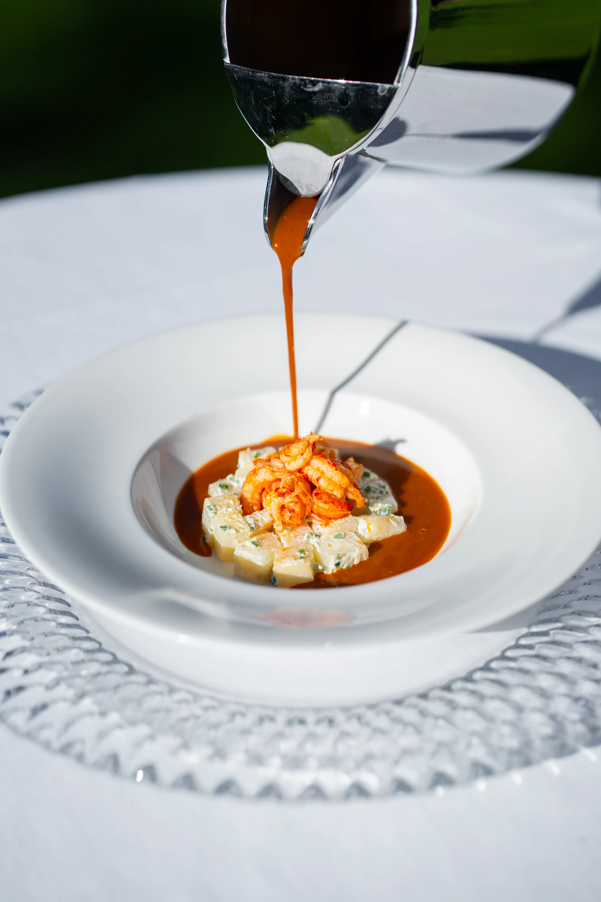 Kreeftenbisque wordt aan tafel over de salade van rivierkreeft geschonken