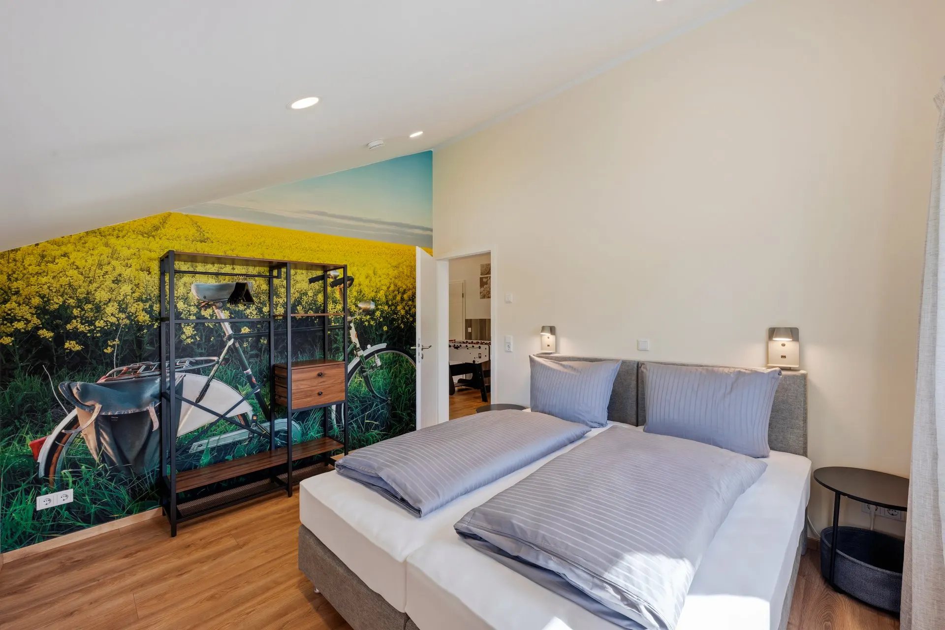 Schlafzimmer mit zwei Betten und Fahrradmotiv an der Wand