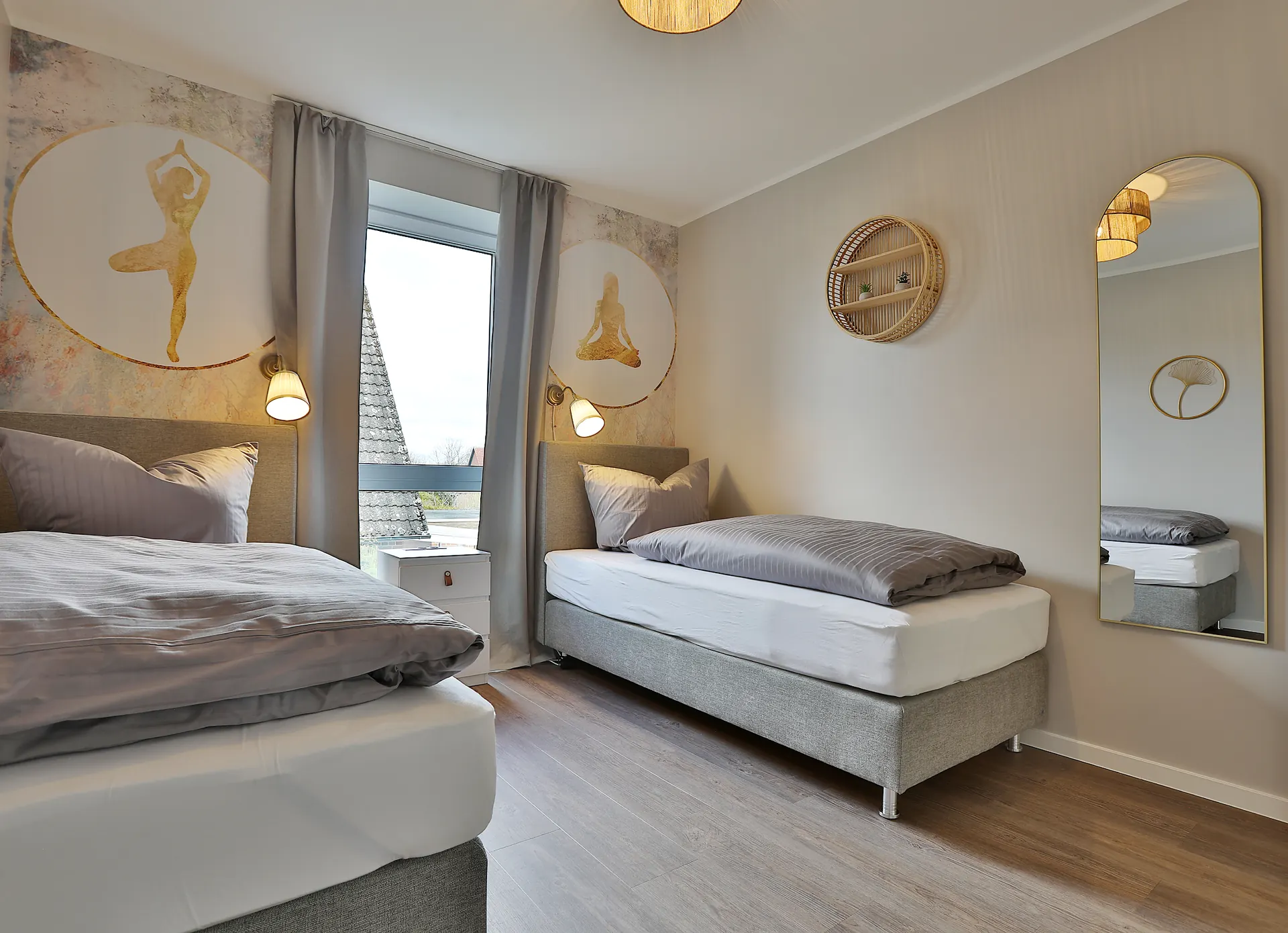 Schlafzimmer mit Yoga-Motiven und großem Wandspiegel
