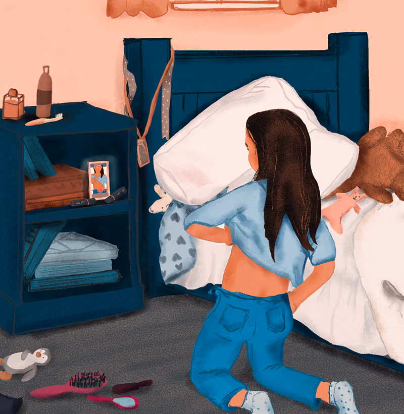 Girl kneeling beside a bed in a messy room with toys, hairbrushes, and clothes scattered on the floor.