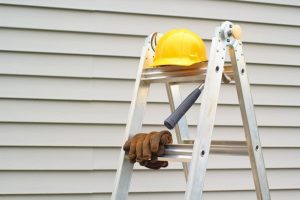 contractor equipment next to house siding