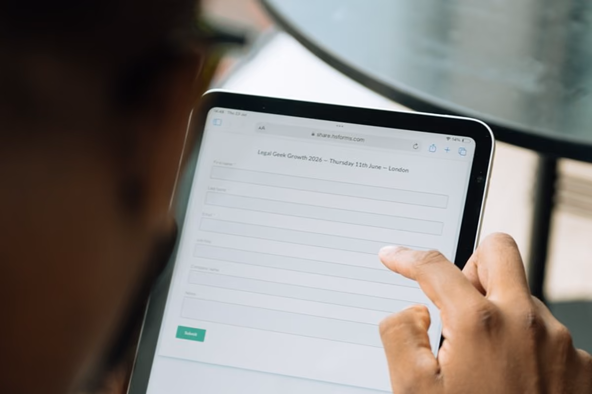 Close-up of a hand filling in an event registration form on a tablet for the Legal Geek Growth 2026 event