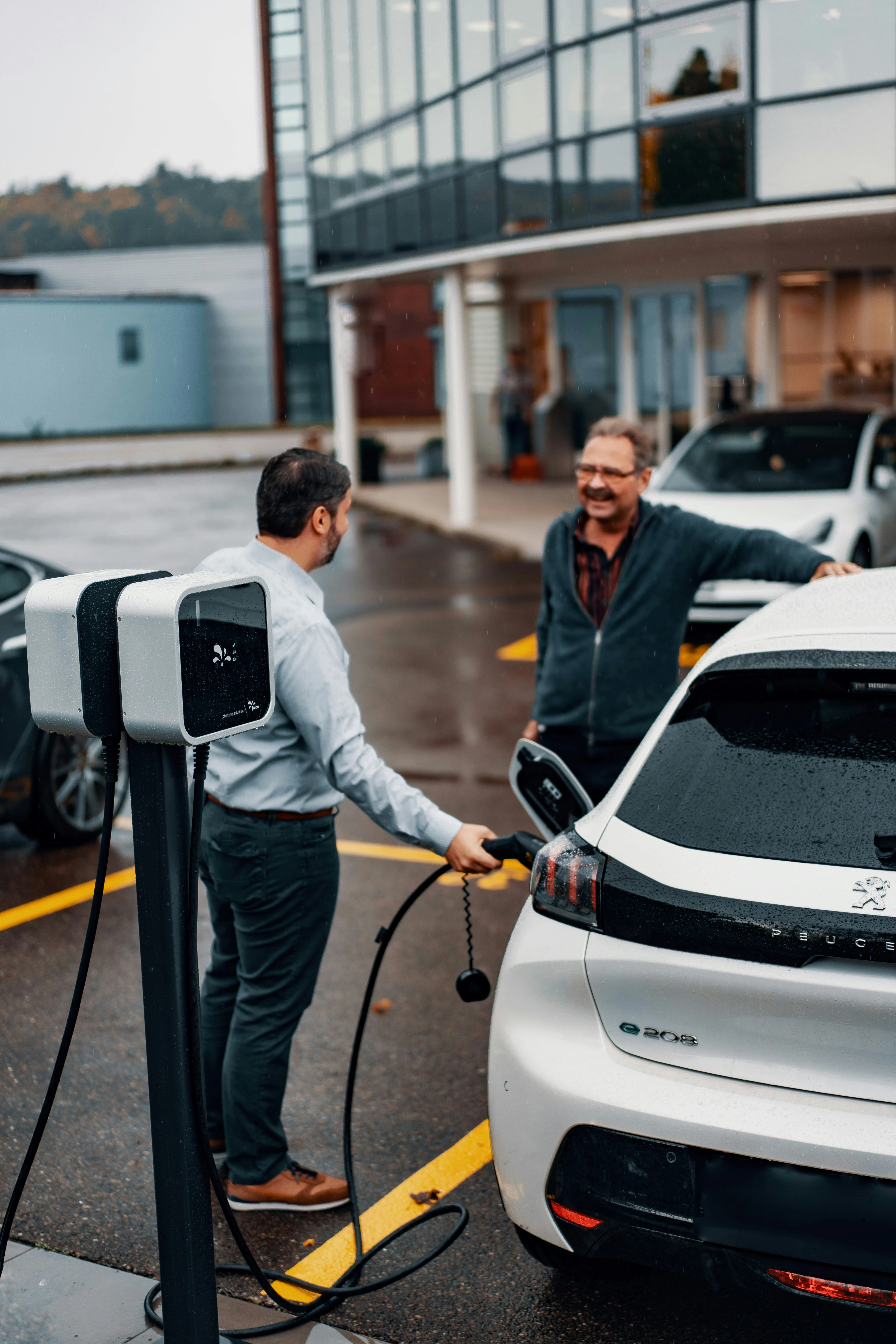 drivers talking during EV charging 