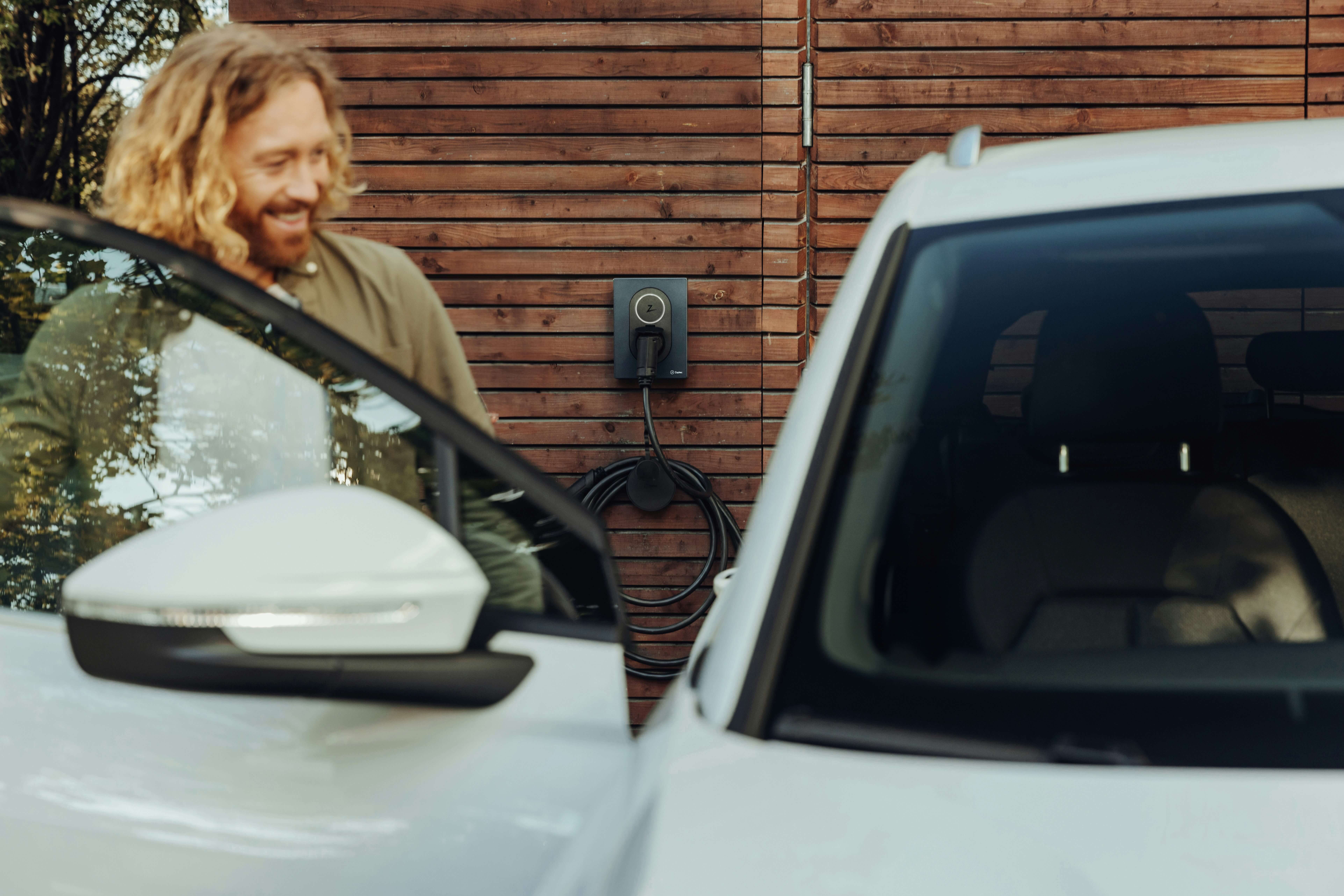 ev driver gets in car 