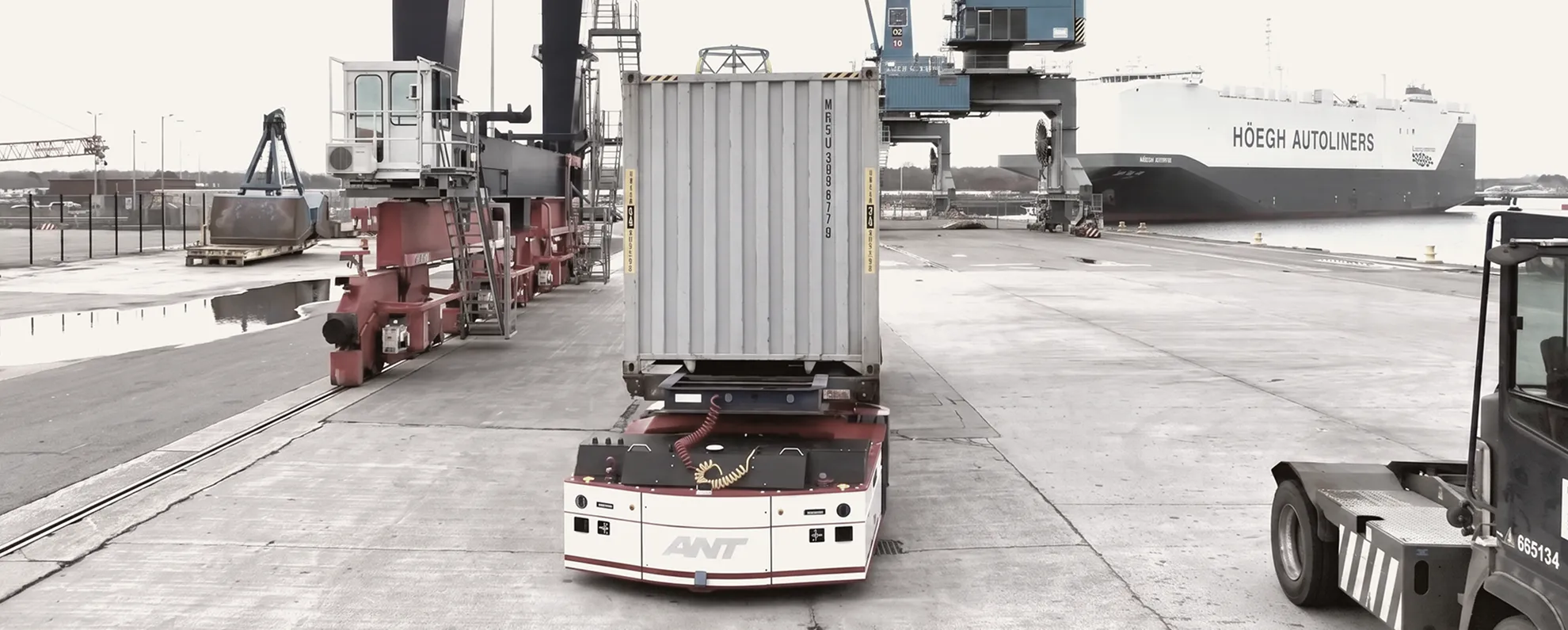 Autonomous mobile robots moving containers point to point in mixed traffic