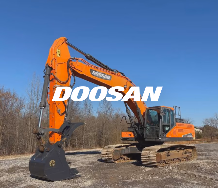 Orange Doosan excavator with a large bucket attachment parked on a gravel surface with leafless trees and a clear blue sky in the background.