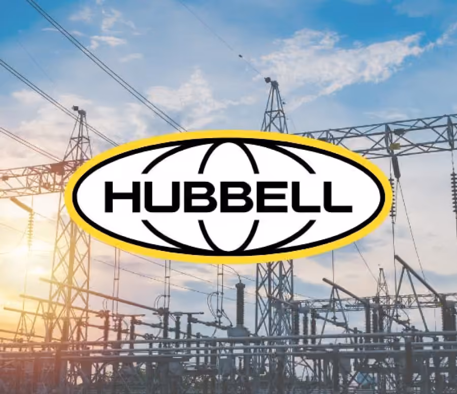 Hubbell company logo over an electrical power substation with transmission towers and wires at sunset.