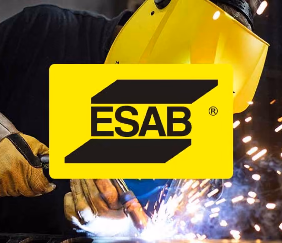 Person welding metal with protective gear including a yellow welding helmet and gloves, sparks flying around; ESAB logo in yellow and black overlayed on the image.