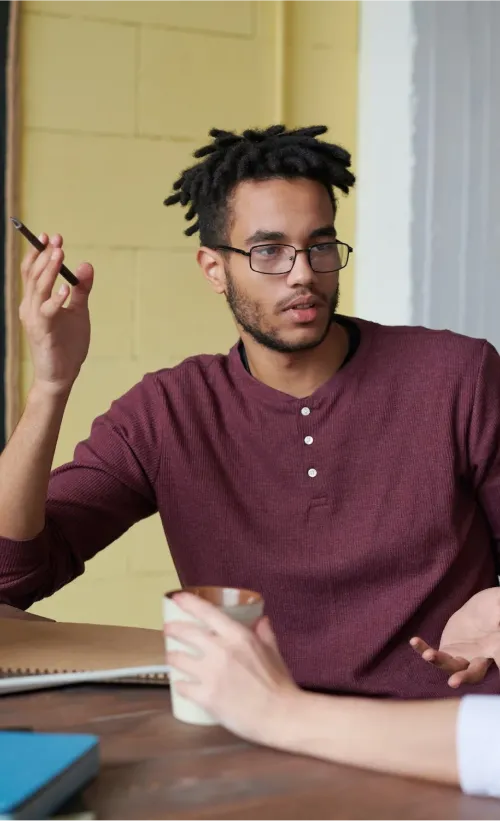 IT professional talking during a team meeting