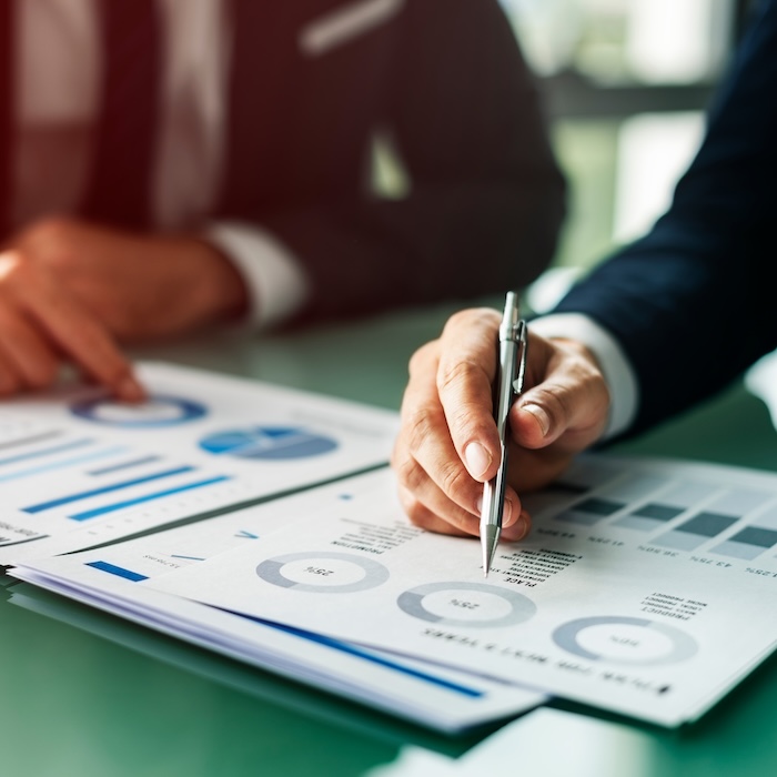 Reviewing printed business reports and metrics