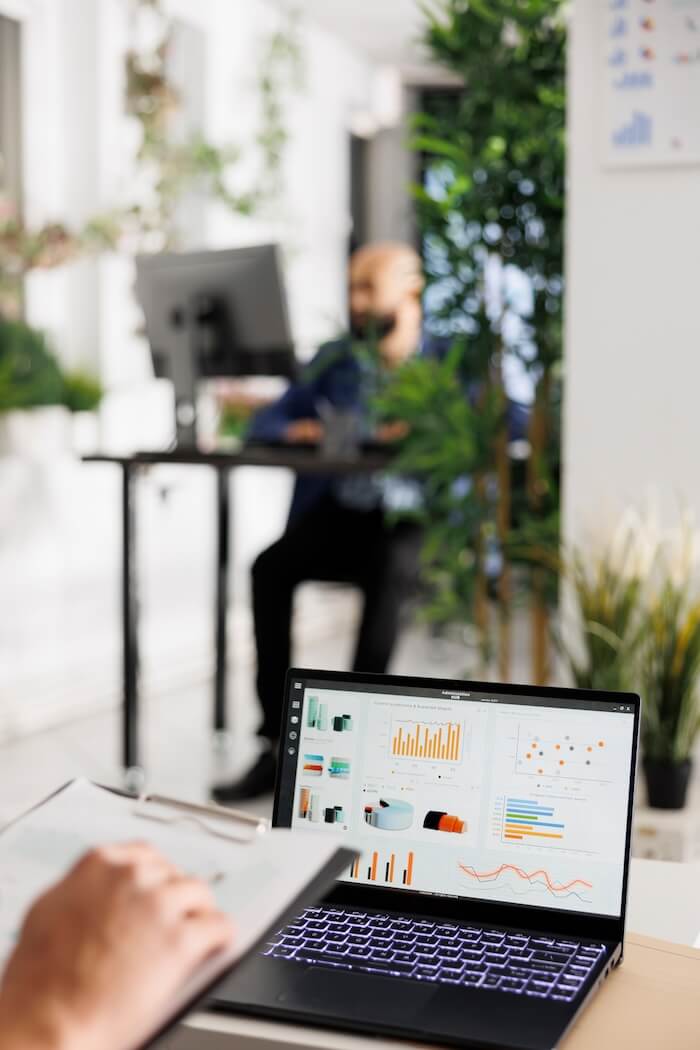 Analyst reviewing data dashboards on a laptop in the office