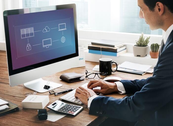 Professional configuring network security from his desktop computer