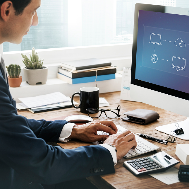 IT professional monitoring cloud infrastructure from his desk