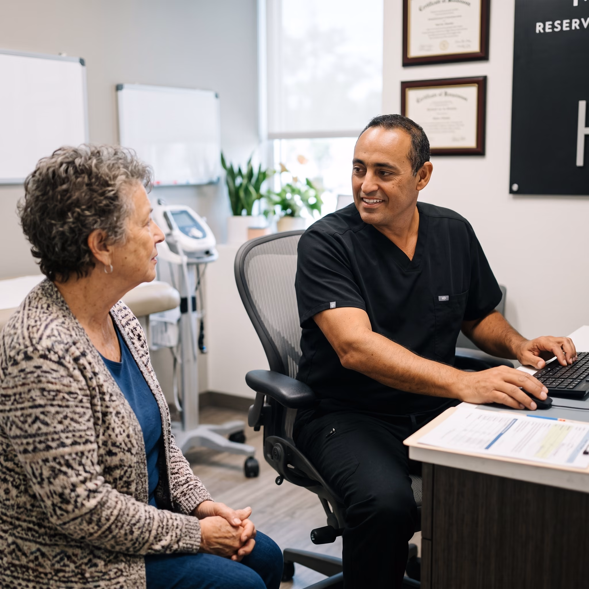 Dr. Mike meeting with a patient in a casual office setting. both are smiling
