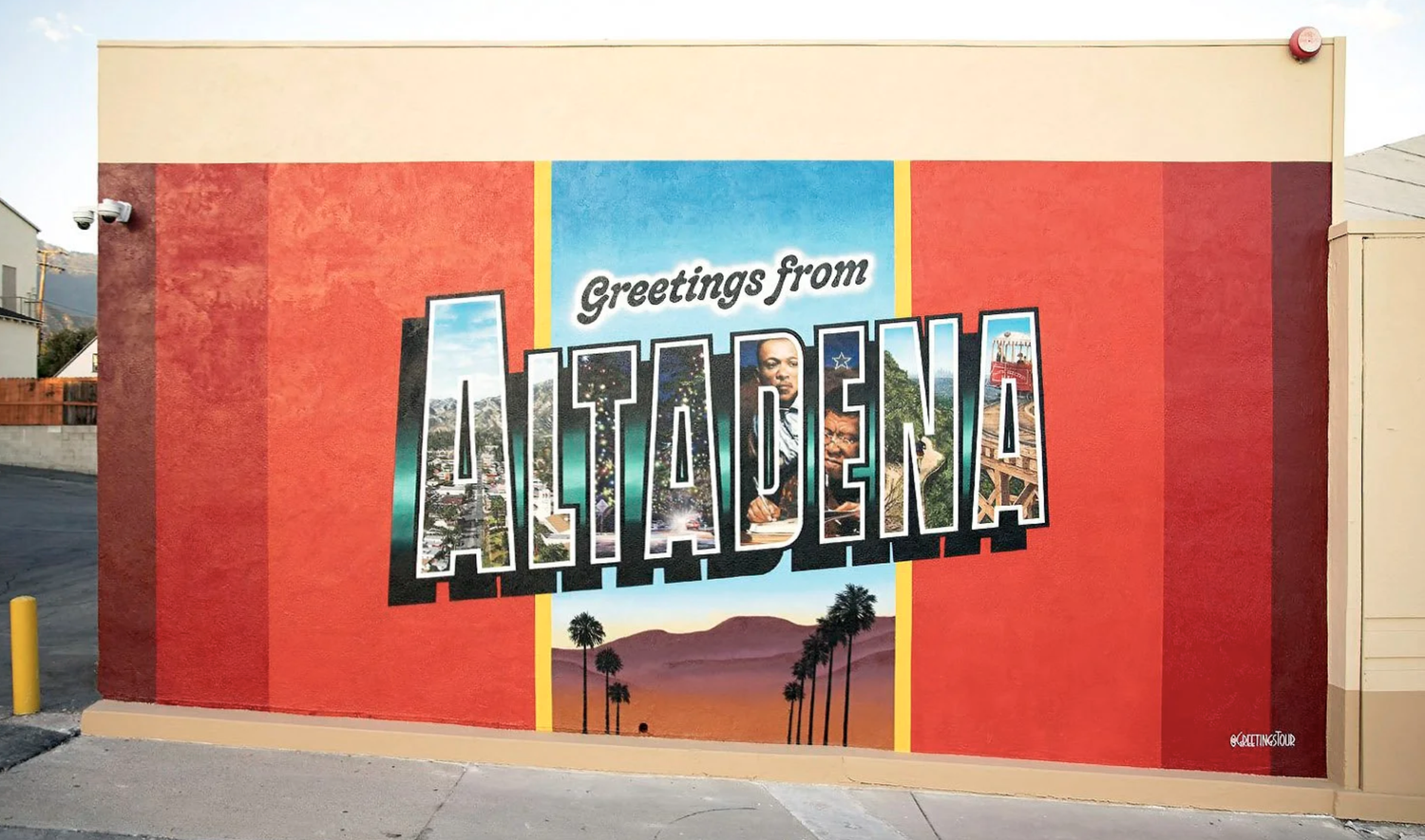 Postcard-style mural on a red wall with large letters reading Greetings from Altadena above palm trees