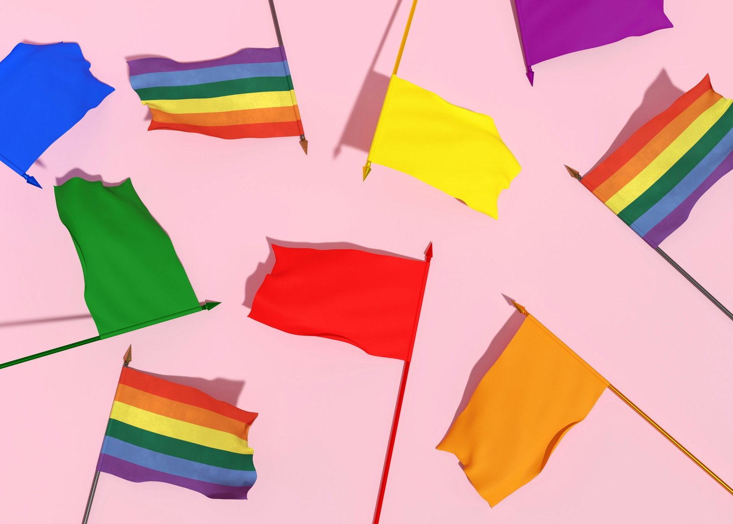 Scattered rainbow flags and solid blue, green, red, yellow, orange and purple flags on a pink background