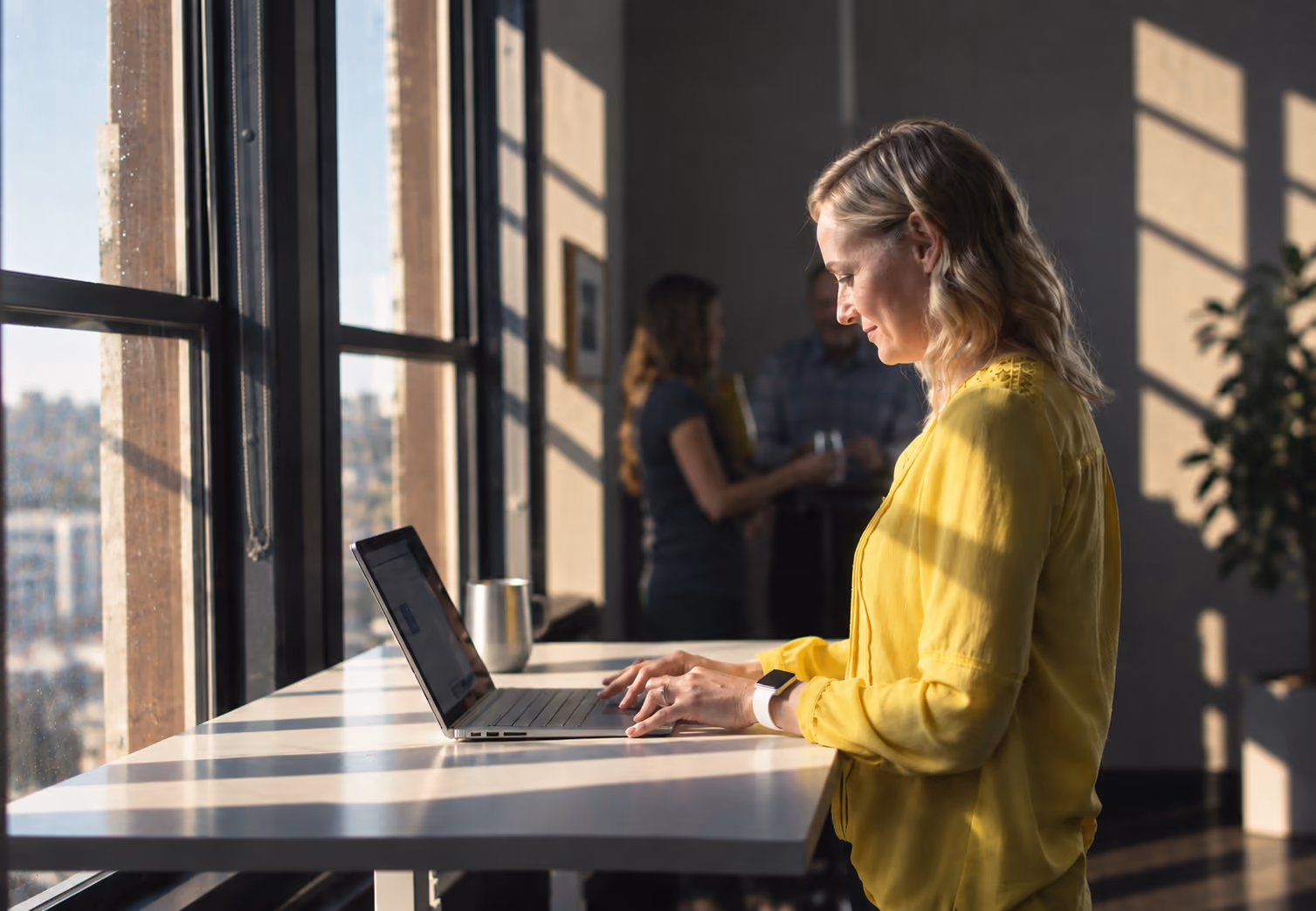 Person reviewing claims on a laptop by a window
