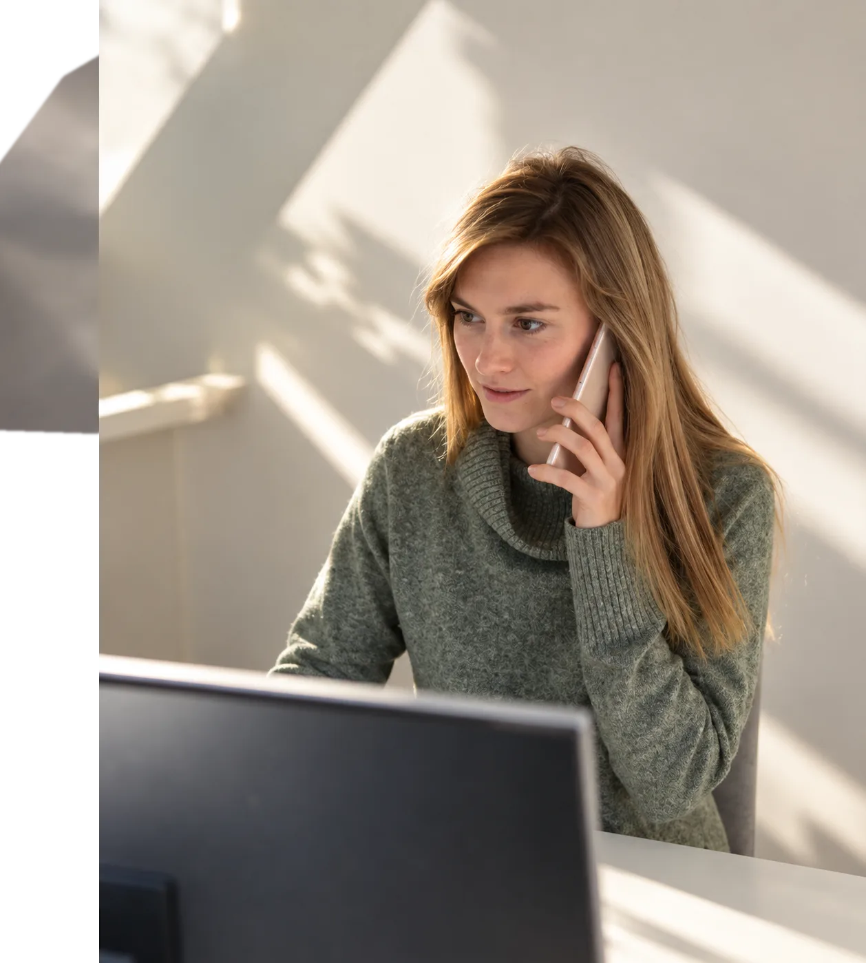 A plan manager on a phone call at her desk