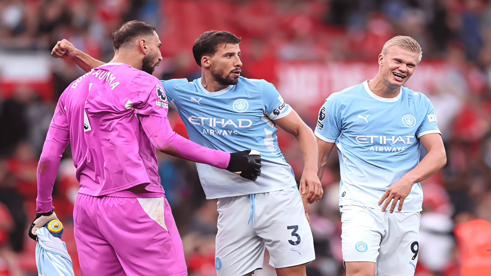 Donnarumma, Dias and Haaland celebrate Manchester City's derby win at Old Trafford.