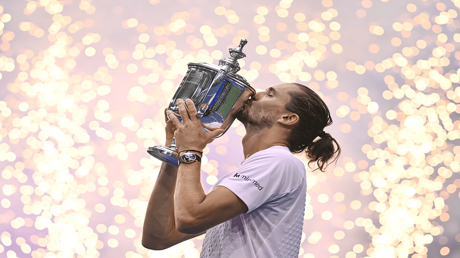 Alexander Zverev kisses the US Open trophy after beating Ben Shelton in the 2026 men's final at Arthur Ashe Stadium.