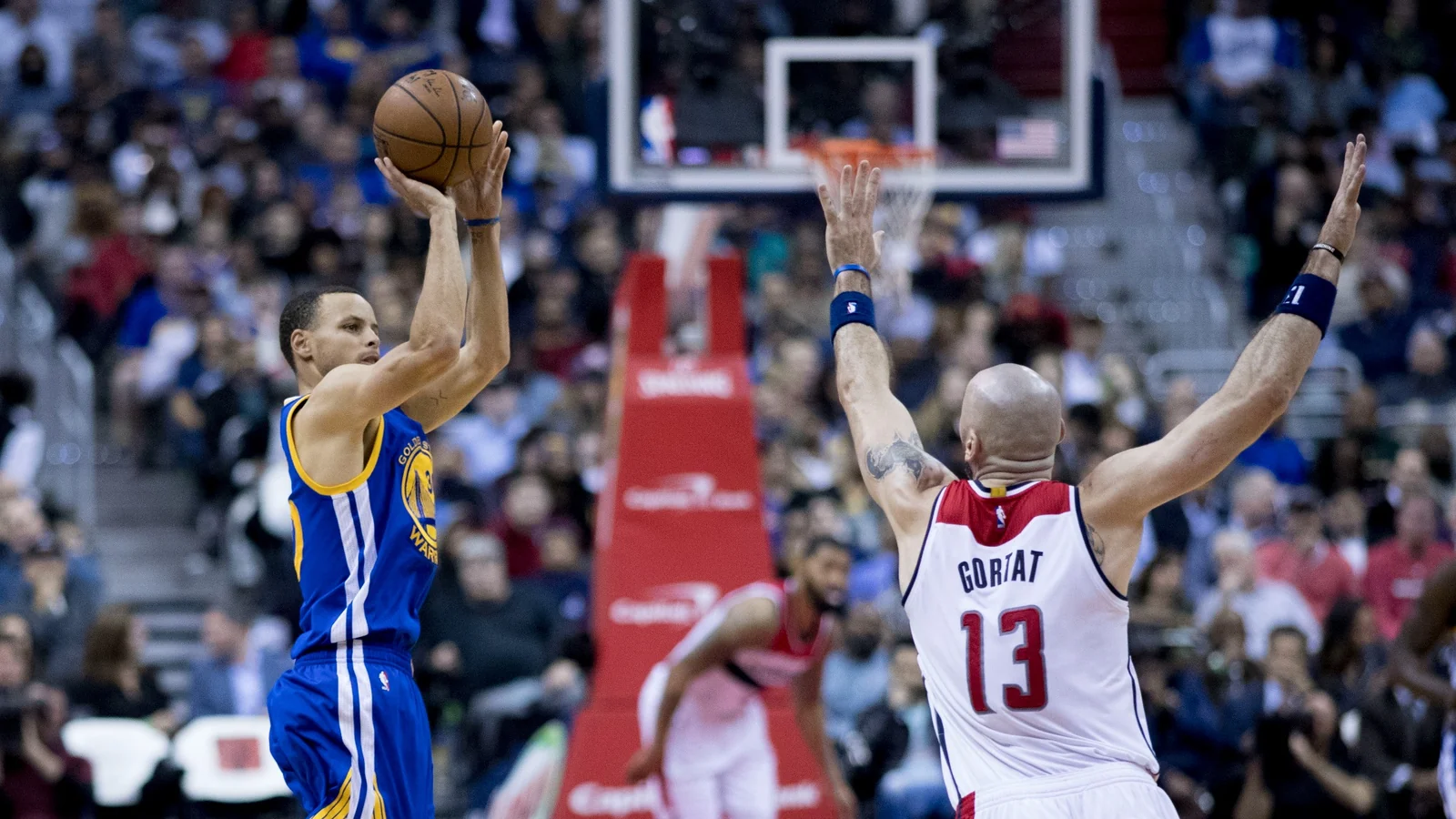 Stephen Curry of the Golden State Warriors shoots in front of Marcin Gortat during a game against the Washington Wizards in 2017.