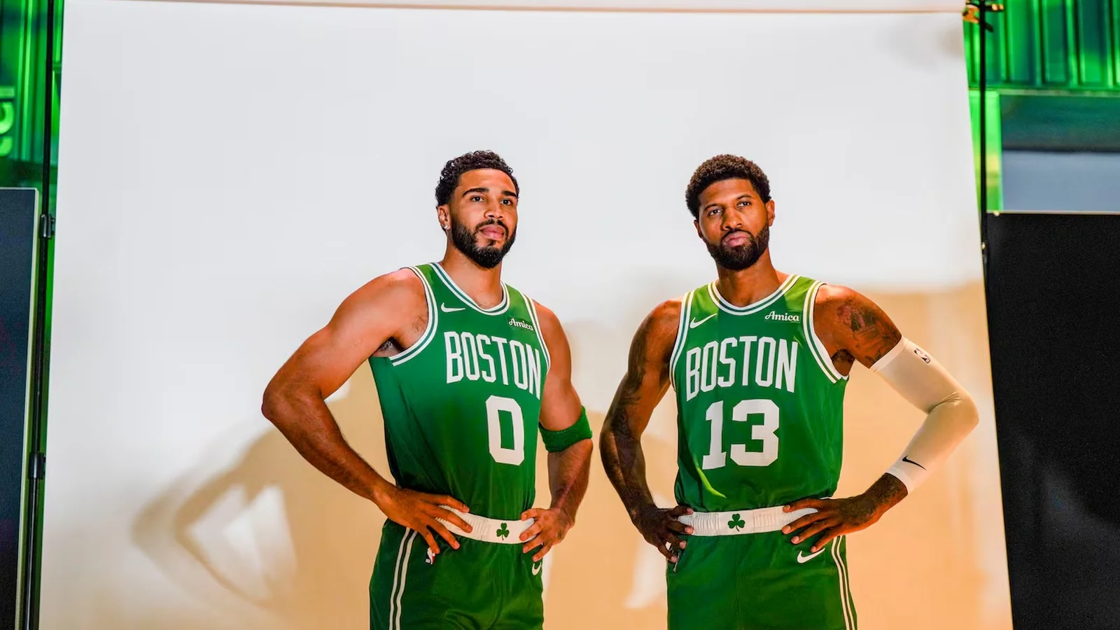 Jayson Tatum and Paul George pose in green Boston Celtics jerseys