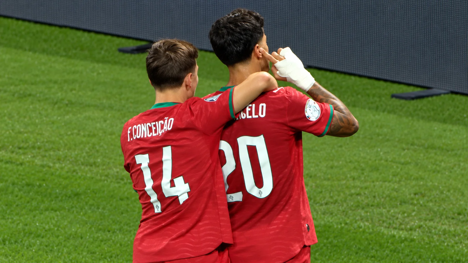 Francisco Conceição embraces João Cancelo as they celebrate for Portugal against Norway.