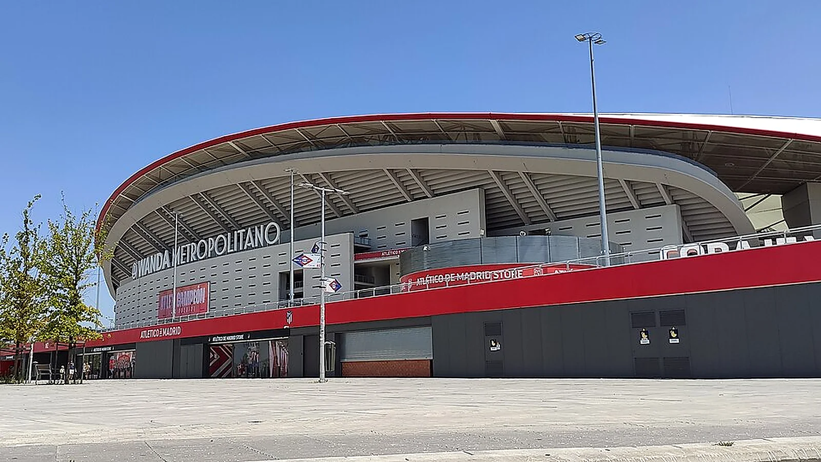 Exterior view of Atlético Madrid’s Riyadh Air Metropolitano stadium in Madrid under a clear blue sky.