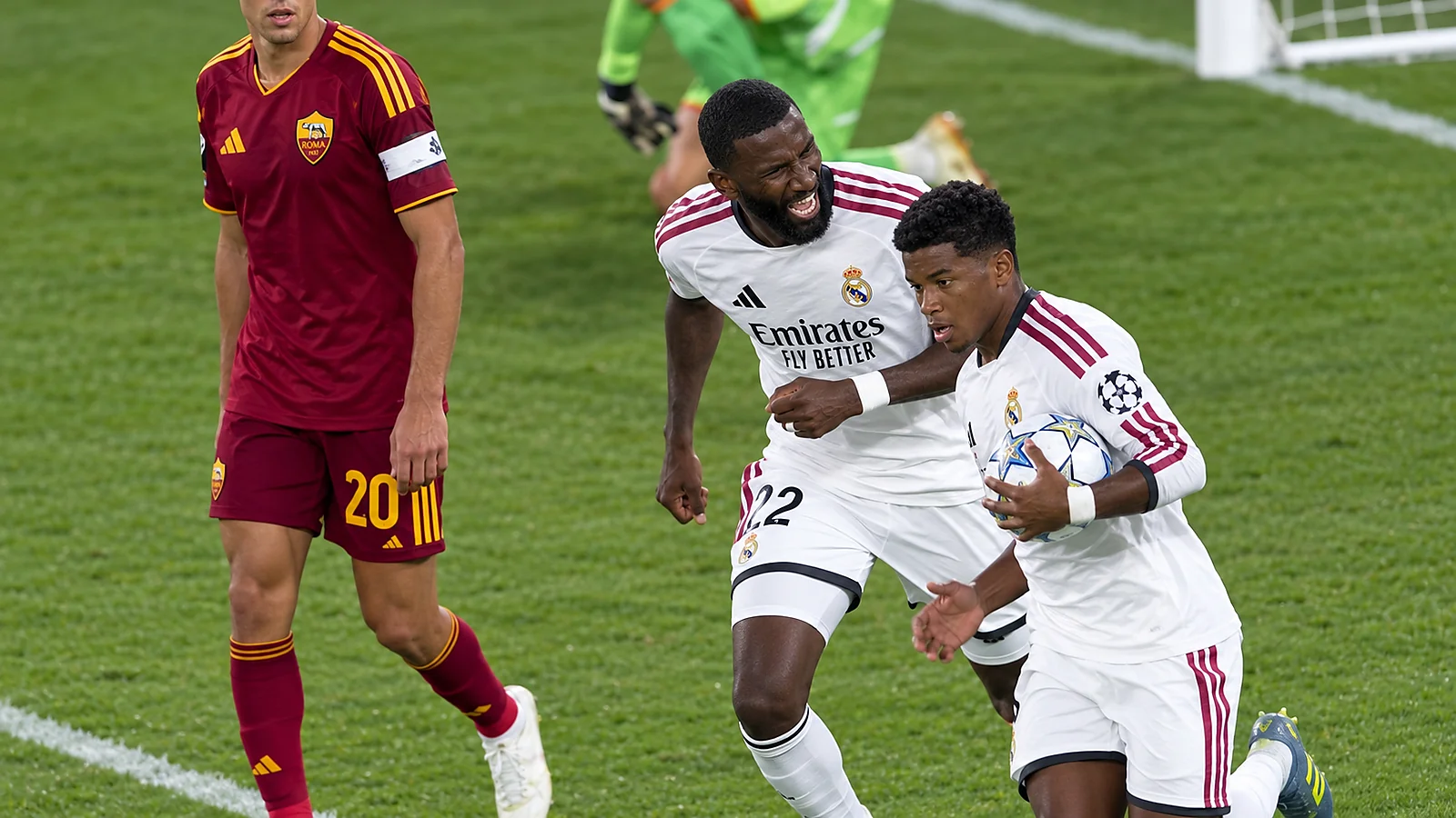 Real Madrid players celebrate with the ball during a Champions League match against Roma.