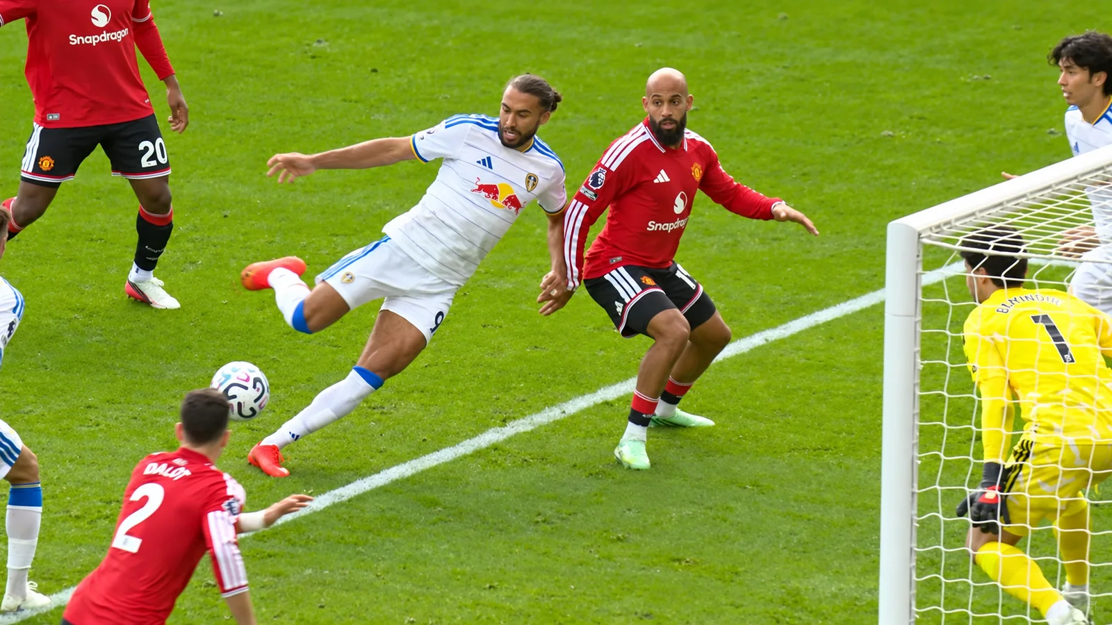 Manchester United defend inside the penalty area as an opposing player attempts a shot near goal.