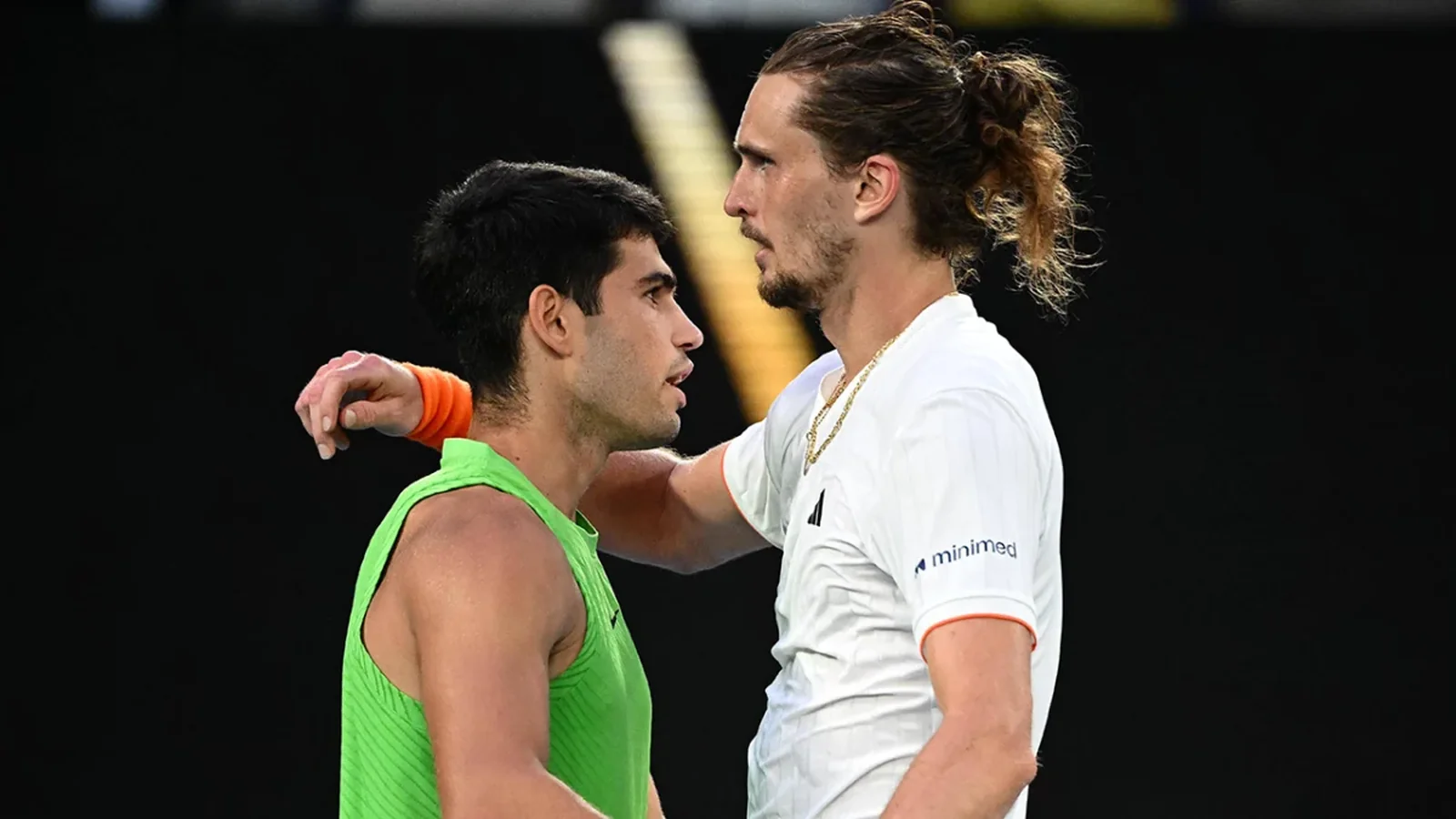 Carlos Alcaraz and Alexander Zverev meet at the net after their match at the Vienna Open.