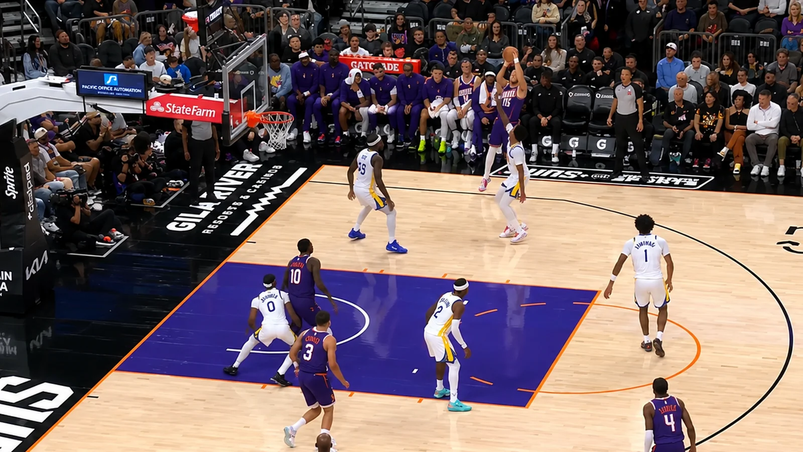 Devin Booker rises for a jump shot as the Phoenix Suns face the Golden State Warriors.