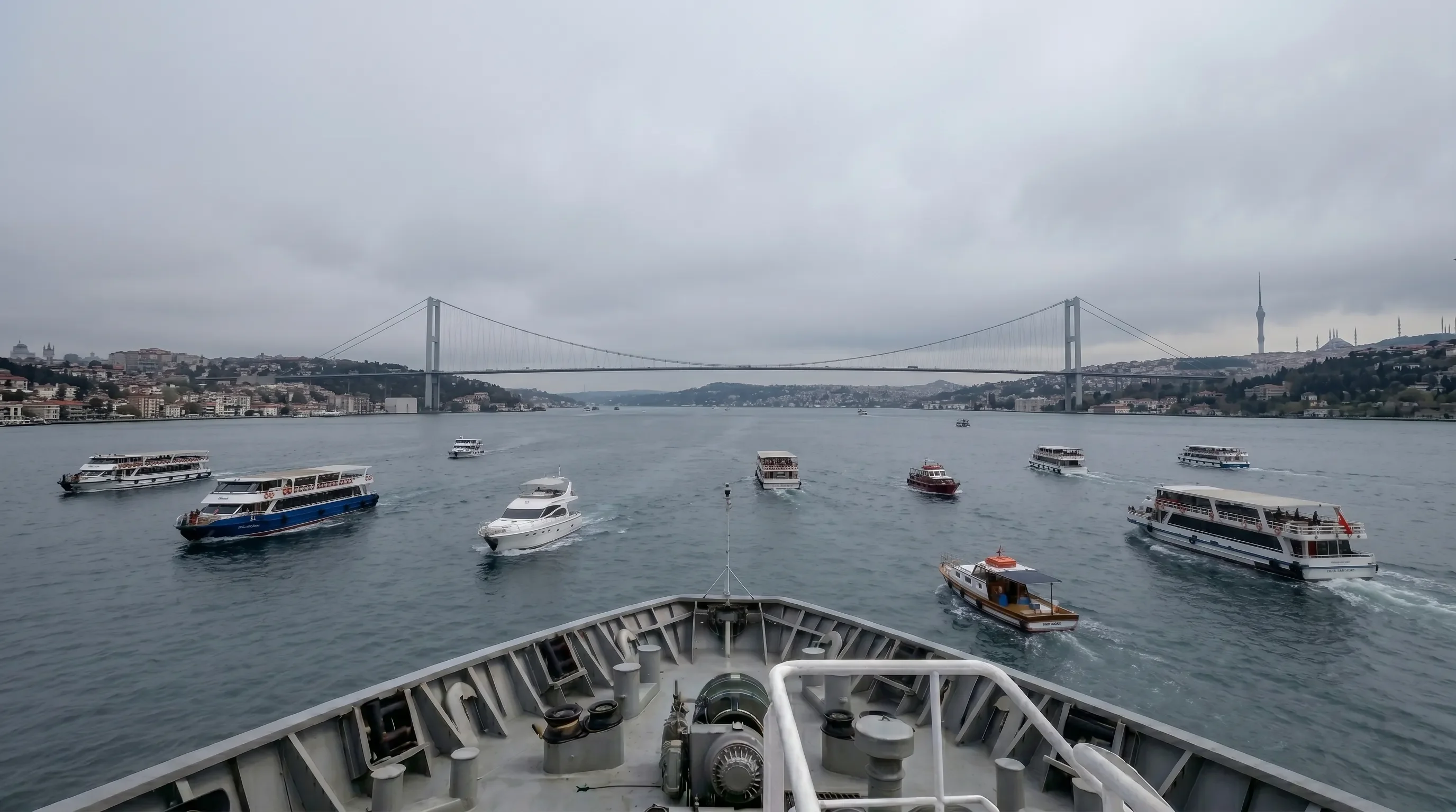 View from a ship's bow of maritime traffic near a suspension bridge