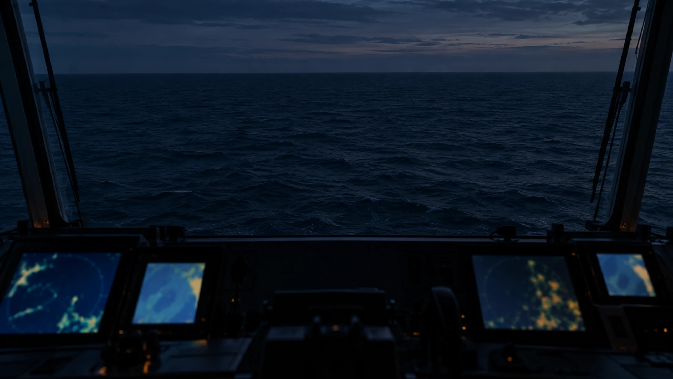 Ship's bridge at dusk with lit instrument displays along the console and open sea beyond