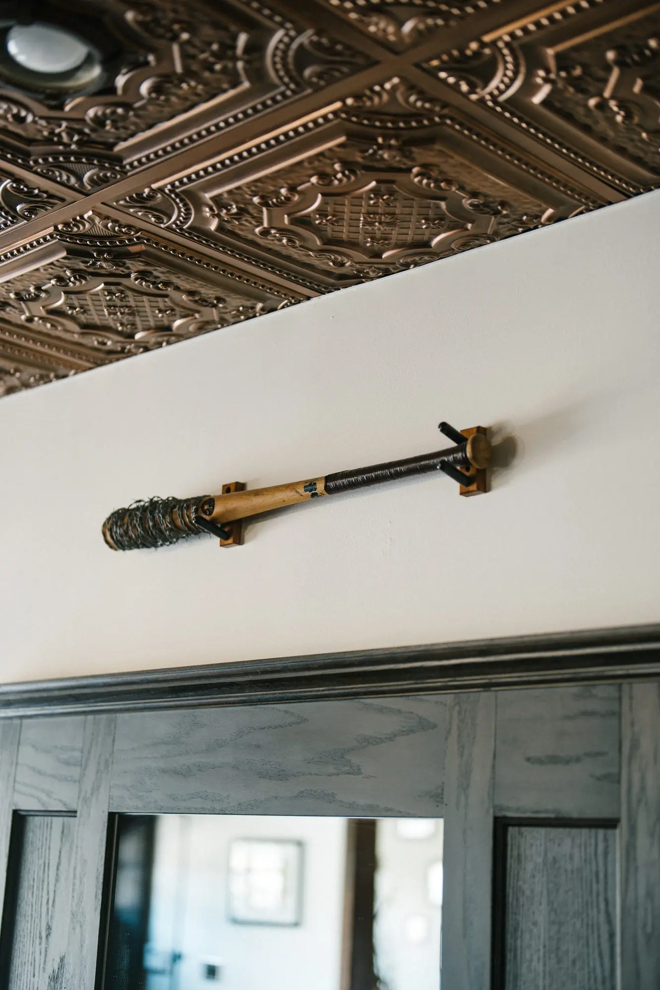 A leather strop hanging beneath the pressed tin ceiling at The Stray Hare