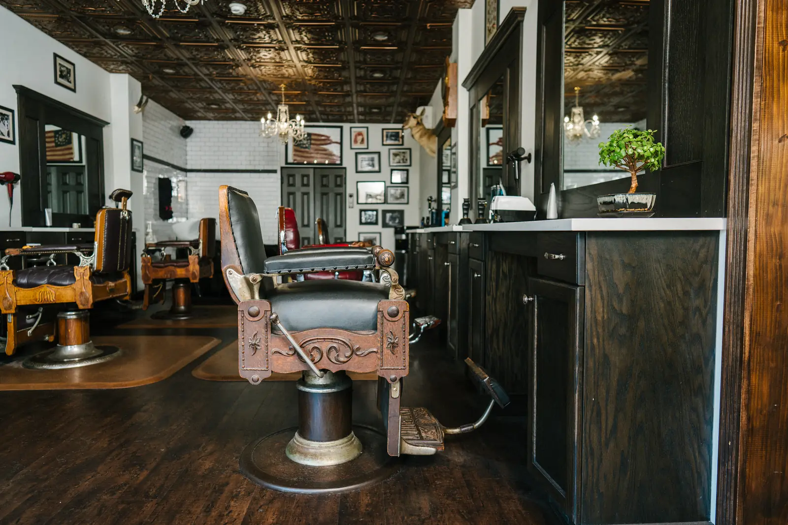 An antique barber chair at a station on the shop floor at The Stray Hare