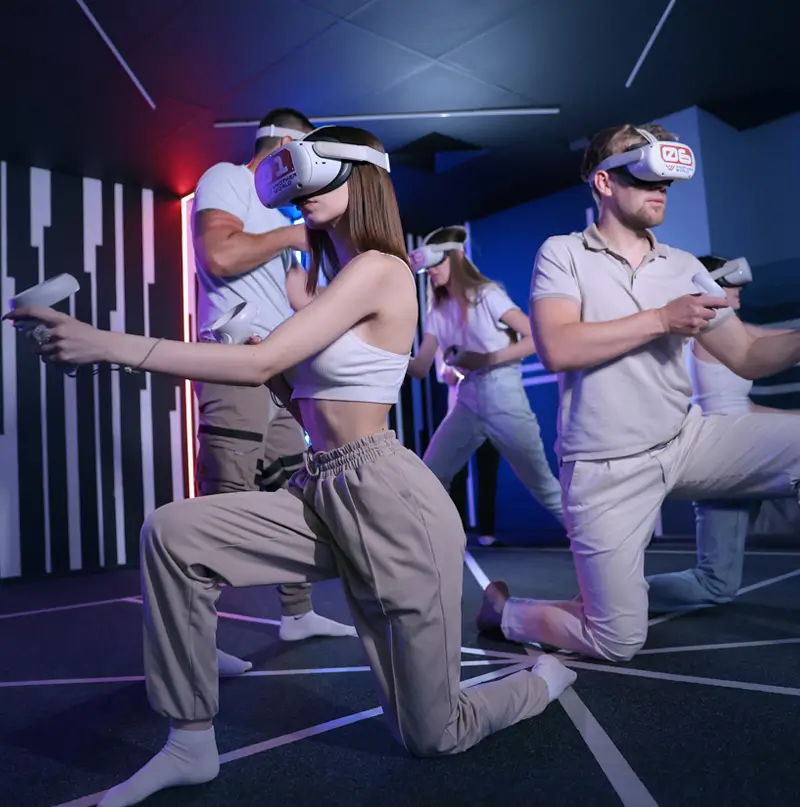 Three players moving freely in the VR arena in headsets