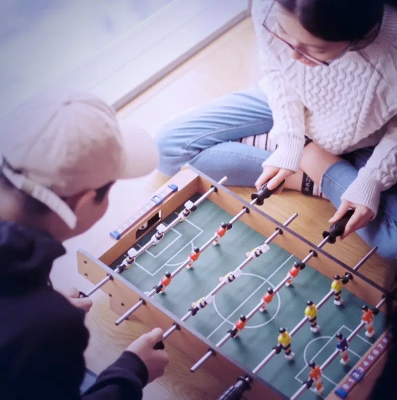 Guests playing foosball in the party lounge between VR sessions