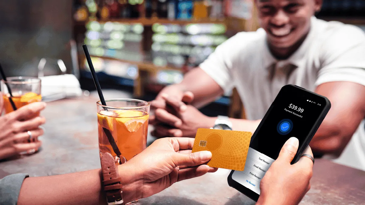 Card being handed across the bar to pay for a round