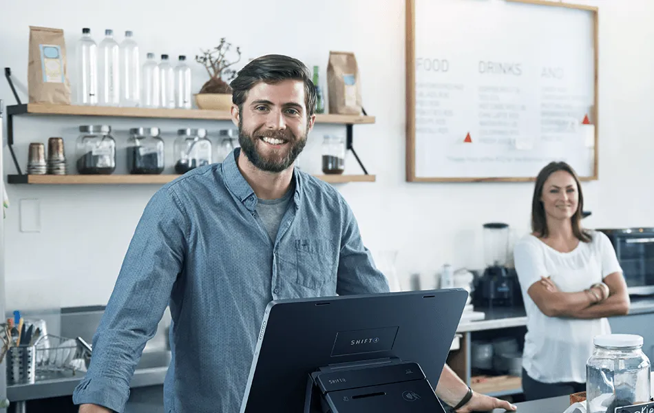 Owner standing behind the counter of one of his sites