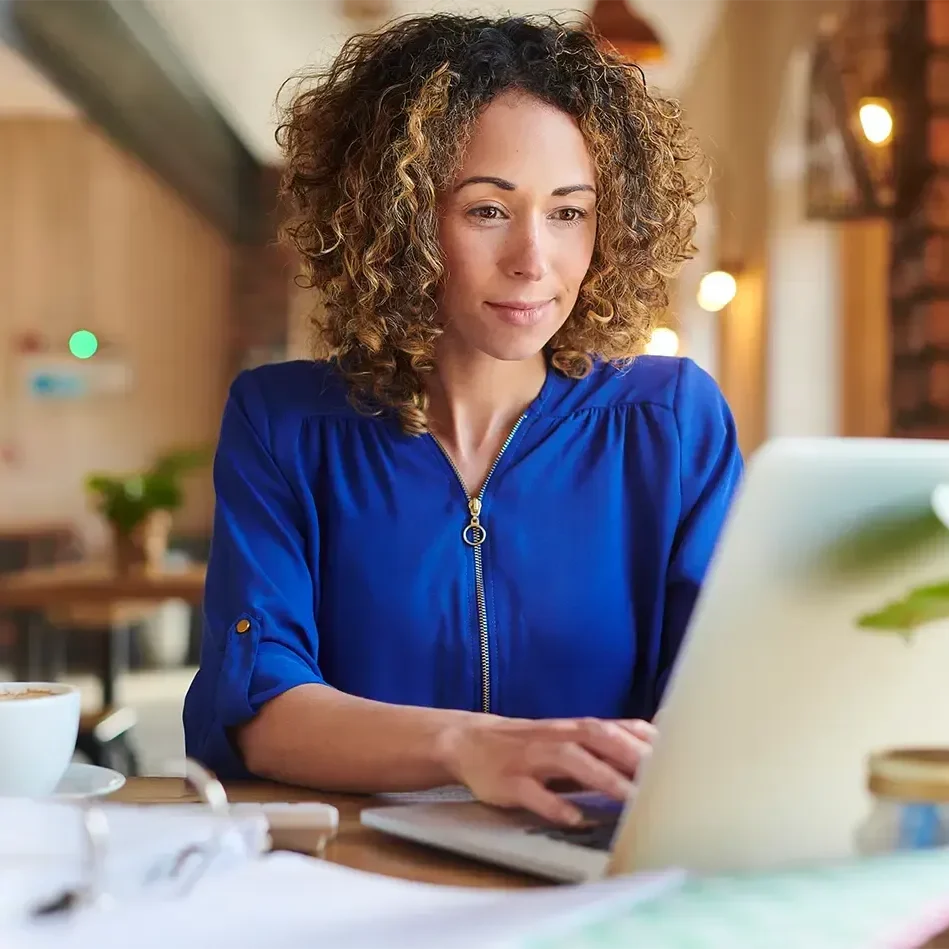 Operator reviewing trading reports on a laptop in the dining room